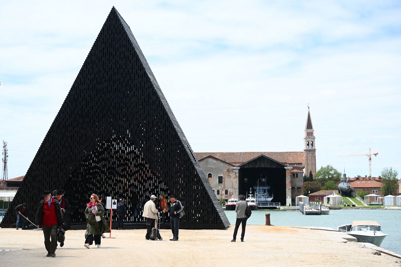 Visitors look at the installation "KwaeE" by Adjaye Associated at the 18th International Architecture Exhibition in Venice on May 18, 2023, during a press day. The Biennale, entitled "The Laboratory of the Future ", curated by Ghanaian-Scottish architect, educator, and novelist Lesley Lokko, will open on May 20 and will run until November 26, 2023 in the Arsenal gardens.