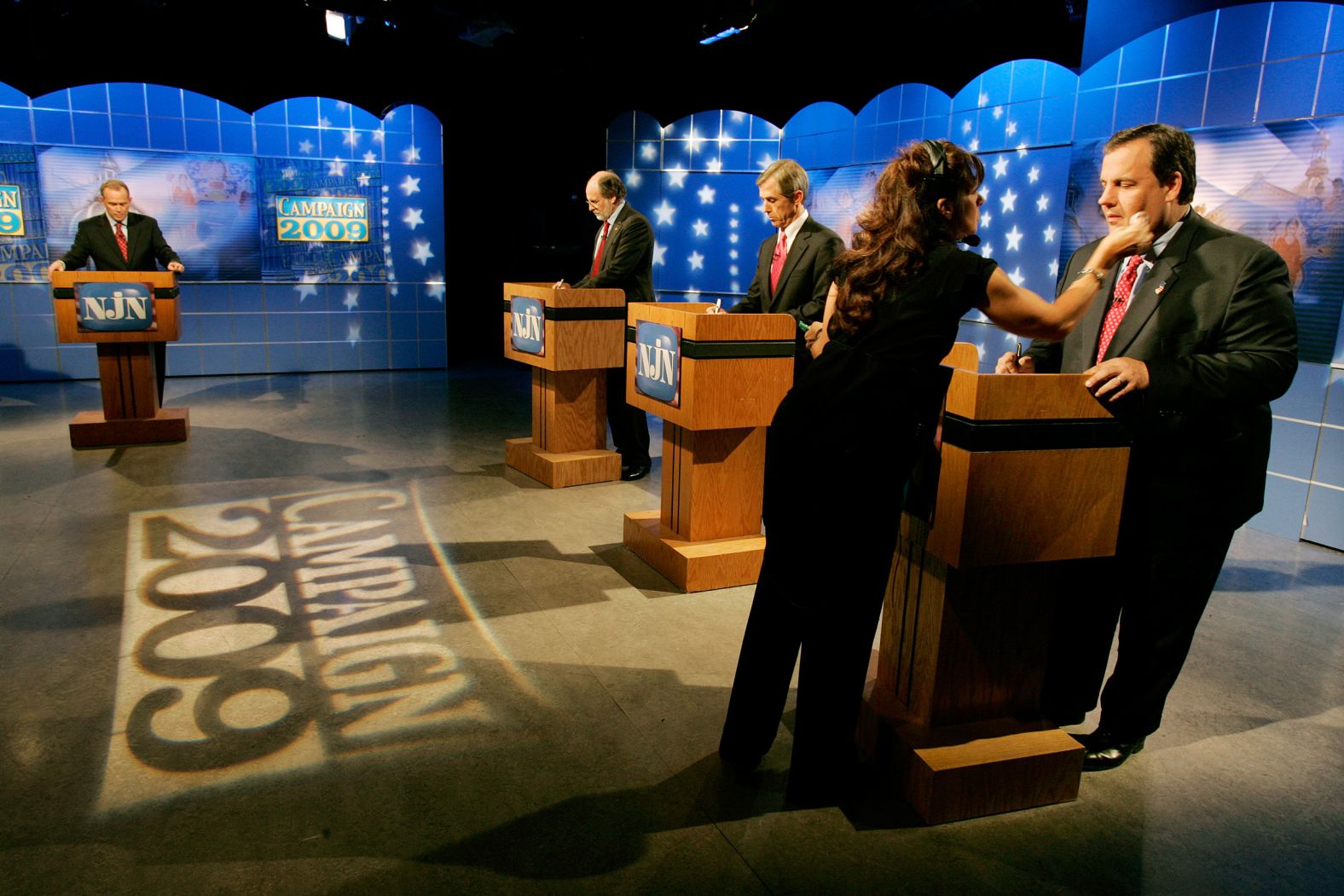 Christie has makeup applied before a gubernatorial debate with Chris Daggett, center, and New Jersey Gov. Jon Corzine in October 2009.