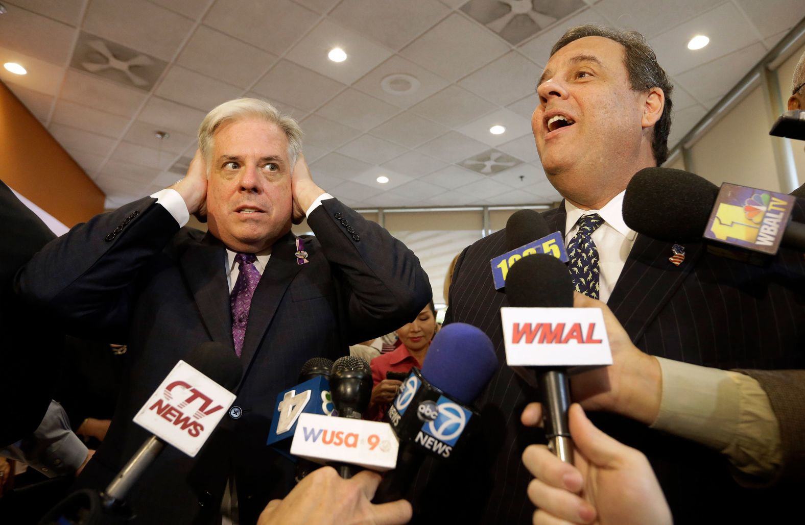 Larry Hogan, who at the time was running for governor of Maryland, pretends not to hear Christie as he speaks to reporters in Bethesda, Maryland, in October 2014. Christie, as head of the Republican Governors Association, was in Maryland to help Hogan's campaign.