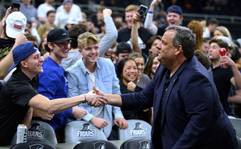 Christie greets students before a college basketball game in Providence, Rhode Island, in 2022.