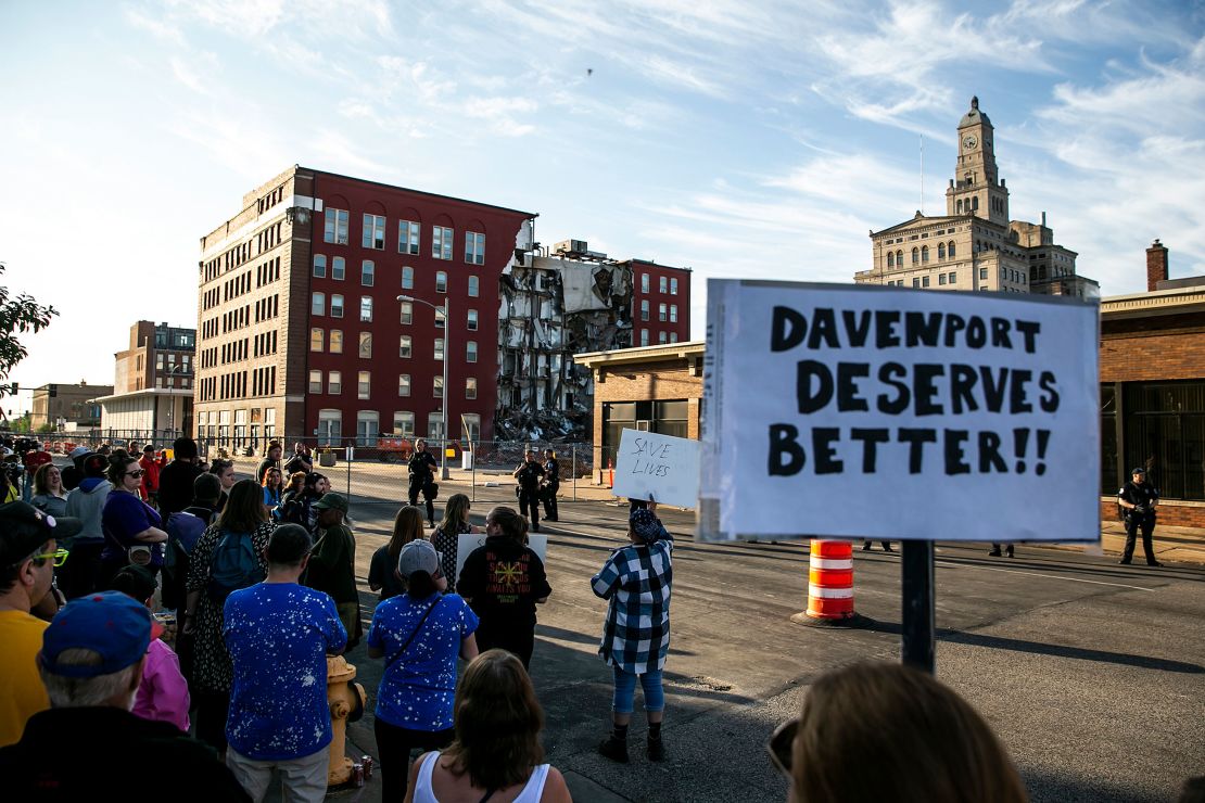 Demonstrators rally Tuesday in support of continuing search efforts at a partially collapsed apartment building. 