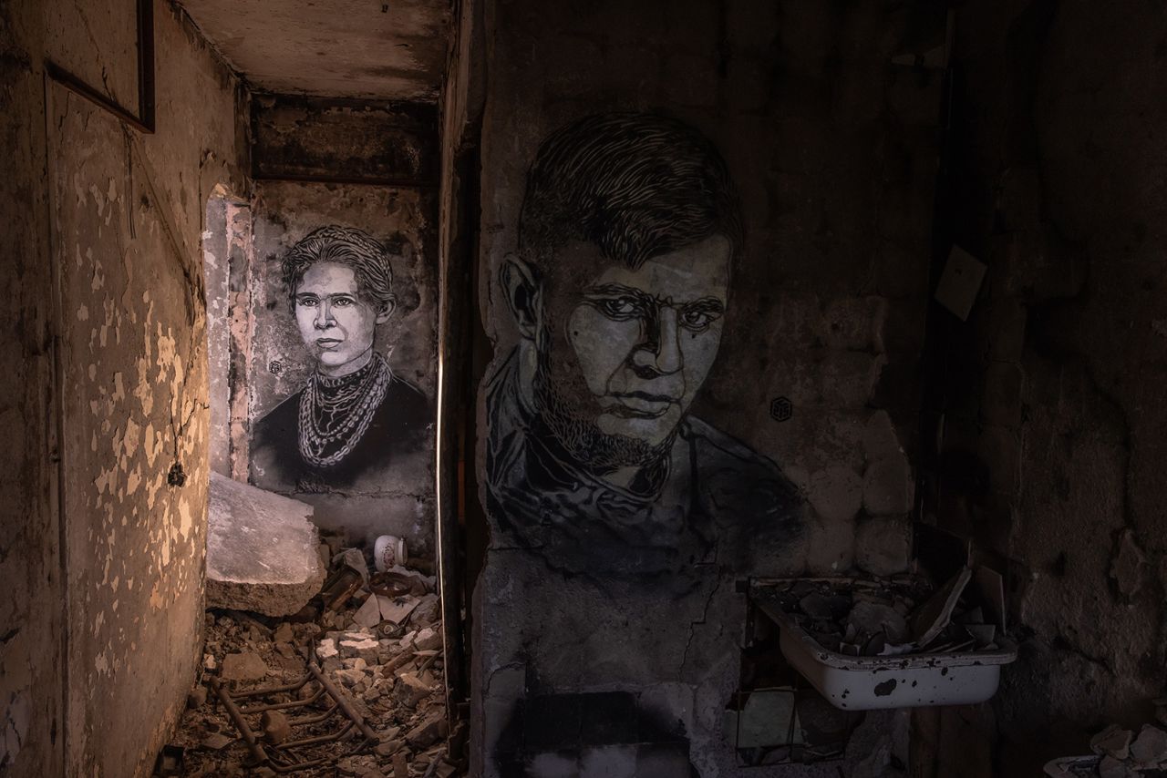 BORODYANKA, UKRAINE - MAY 02:  Portraits done by the French artist Christian Guemy, known as C215, showing one of Ukrainian literature's foremost writers Lesya Ukrainka (L) and Ukrainian serviceman Dmytro Kotsiubailo, known as Da Vinci, who was killed in Bakhmut, on the walls of an apartment in a residential building that was heavily damaged during Russia's attack last year, on May 2, 2023 in Borodyanka, Ukraine. (Photo by Roman Pilipey/Getty Images)