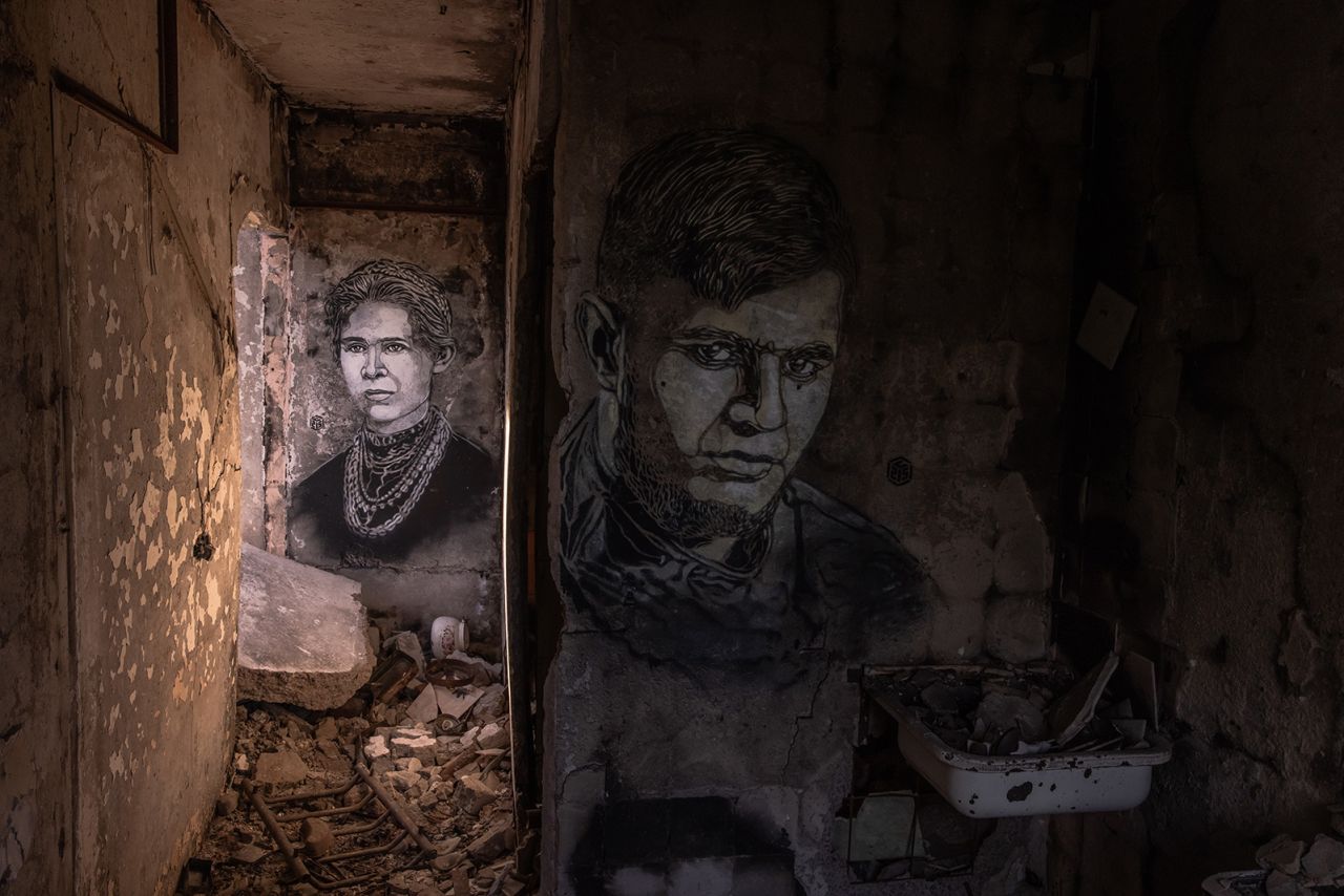 BORODYANKA, UKRAINE - MAY 02: Portraits done by the French artist Christian Guemy, known as C215, showing one of Ukrainian literature's foremost writers Lesya Ukrainka (L) and Ukrainian serviceman Dmytro Kotsiubailo, known as Da Vinci, who was killed in Bakhmut, on the walls of an apartment in a residential building that was heavily damaged during Russia's attack last year, on May 2, 2023 in Borodyanka, Ukraine. (Photo by Roman Pilipey/Getty Images)