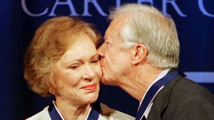 Former President Jimmy Carter (R) kisses former first lady Rosalynn Carter on the cheek after they received the Presidential Medal of Freedom, the nations' highest honor, from President Bill Clinton during a ceremony at the Carter Center in Atlanta, August 9. The Carters were presented with the medals for the work they have done since leaving the White House in 1980.