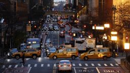 Taxi cabs cross 42nd Street as the sun rises on December 8, 2022, in New York City.  