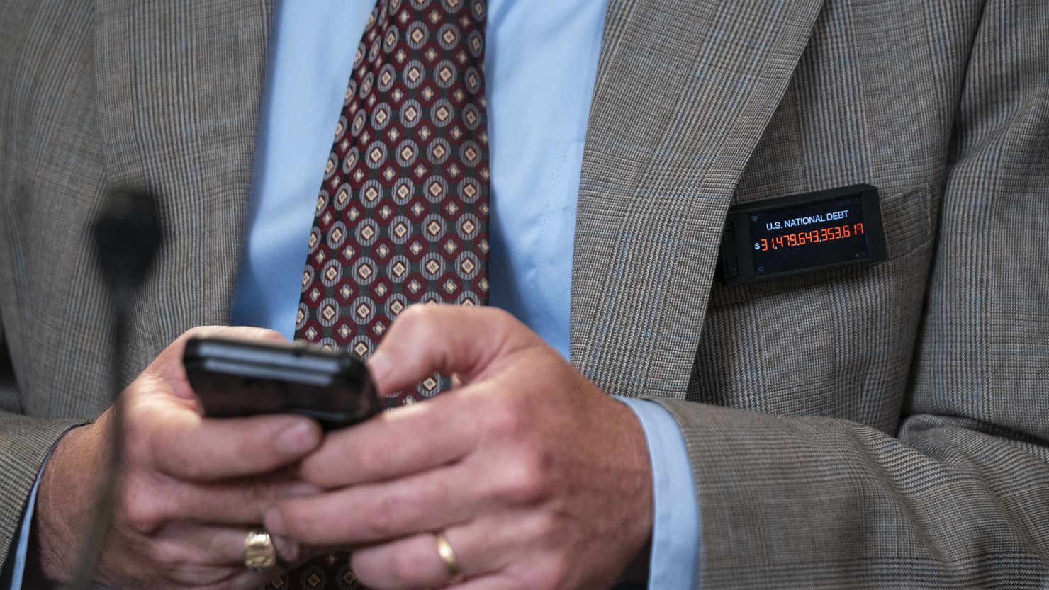 Rep. Thomas Massie, a Republican from Kentucky, wears a digital pin showing the US national debt during a meeting in Washington, DC, on Tuesday, May 30, 2023. 