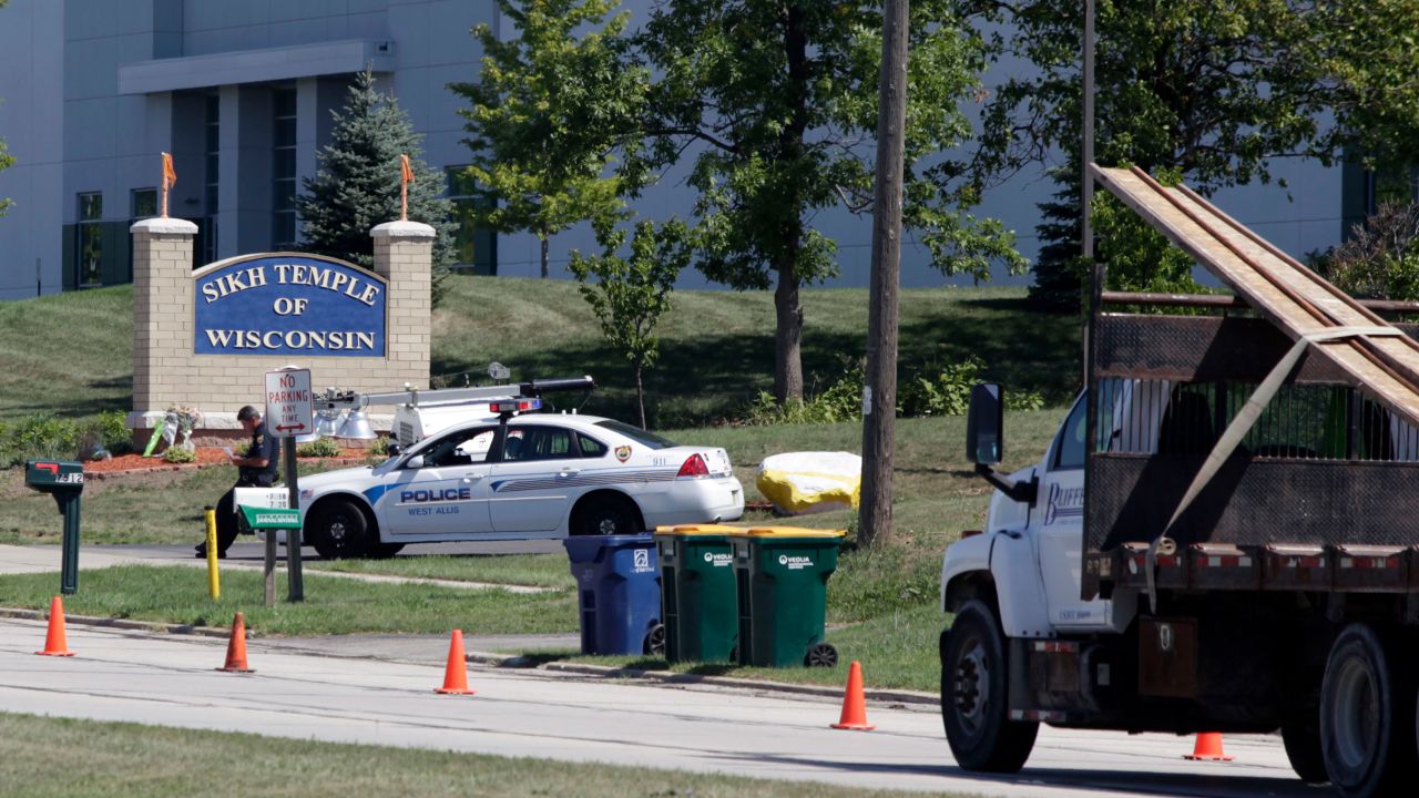 OAK CREEK, WI - AUGUST 7: Police officials stand guard outside the Sikh Temple of Wisconsin August, 7, 2012 Oak Creek Wisconsin. A suspected gunman, 40-year-old Wade Michael Page, allegedly killed six people at the temple August 5, was shot to death by police at the scene. He was an army veteran and reportedly a former leader of a white supremacist heavy metal band. Three others were critically wounded in the attack. (Photo by Darren Hauck/Getty Images)