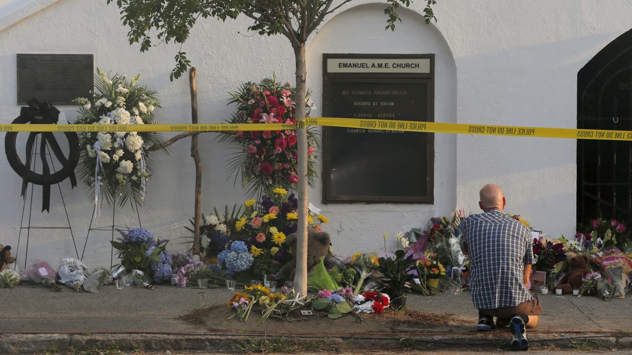 Jake Stephens pays his respects outside the Emanuel African Methodist Episcopal Church in Charleston, South Carolina June 19, 2015, two days after a mass shooting left nine dead during a bible study at the church. REUTERS/Brian Snyder