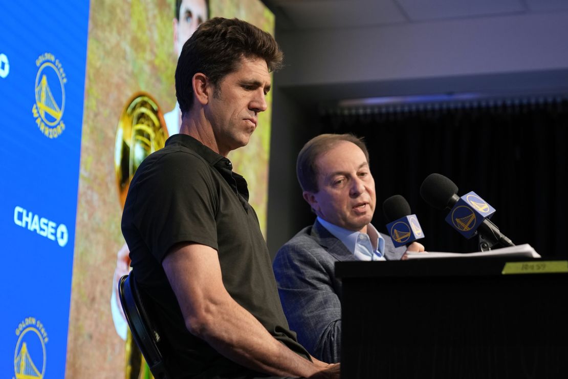 Myers speaks at a press conference next to Golden State Warriors owner Joe Lacob (right). 