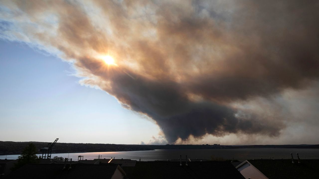 A thick plume of smoke wafts from an out-of-control fire that engulfed multiple homes in Halifax, Nova Scotia, on Sunday.