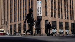 People walk by a Twitter logo at the company headquarters in downtown San Francisco, California, U.S., April 25, 2022. 