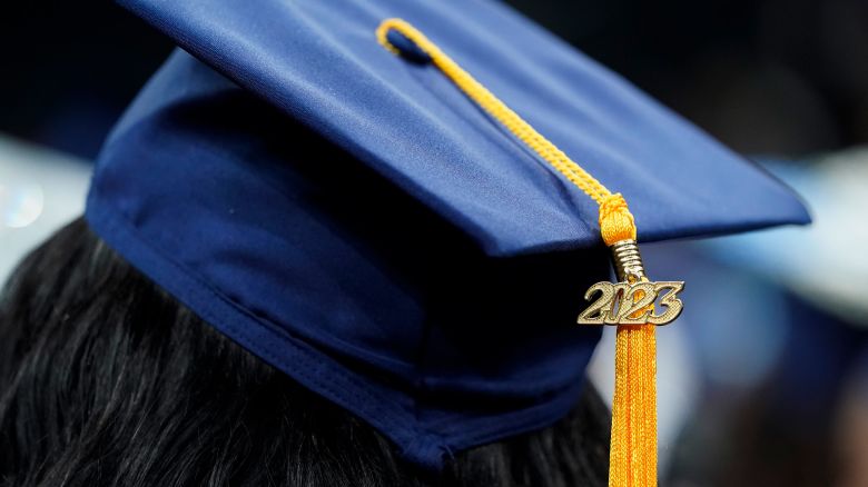 A tassel with 2023 on it rests on a graduation cap as students walk in a procession for Howard University's commencement in Washington, Saturday, May 13, 2023.