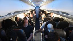 Airline passengers sit during a American Airlines flight operated by SkyWest Airlines from Los Angeles International Airport (LAX) in California to Denver, Colorado on April 19, 2022.