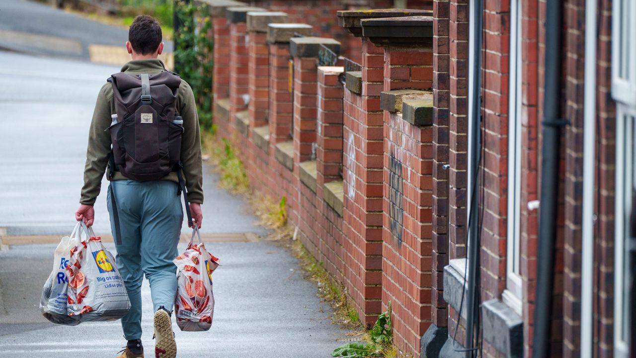 A customer carries groceries in Sheffield, UK, on May 19, 2023. UK food inflation remains above 19%.