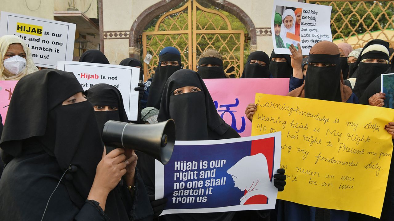 Muslim women hold placards during a demonstration after educational institutes in Karnataka denied entry to students for wearing hijabs, in Bangalore on February 7, 2022.