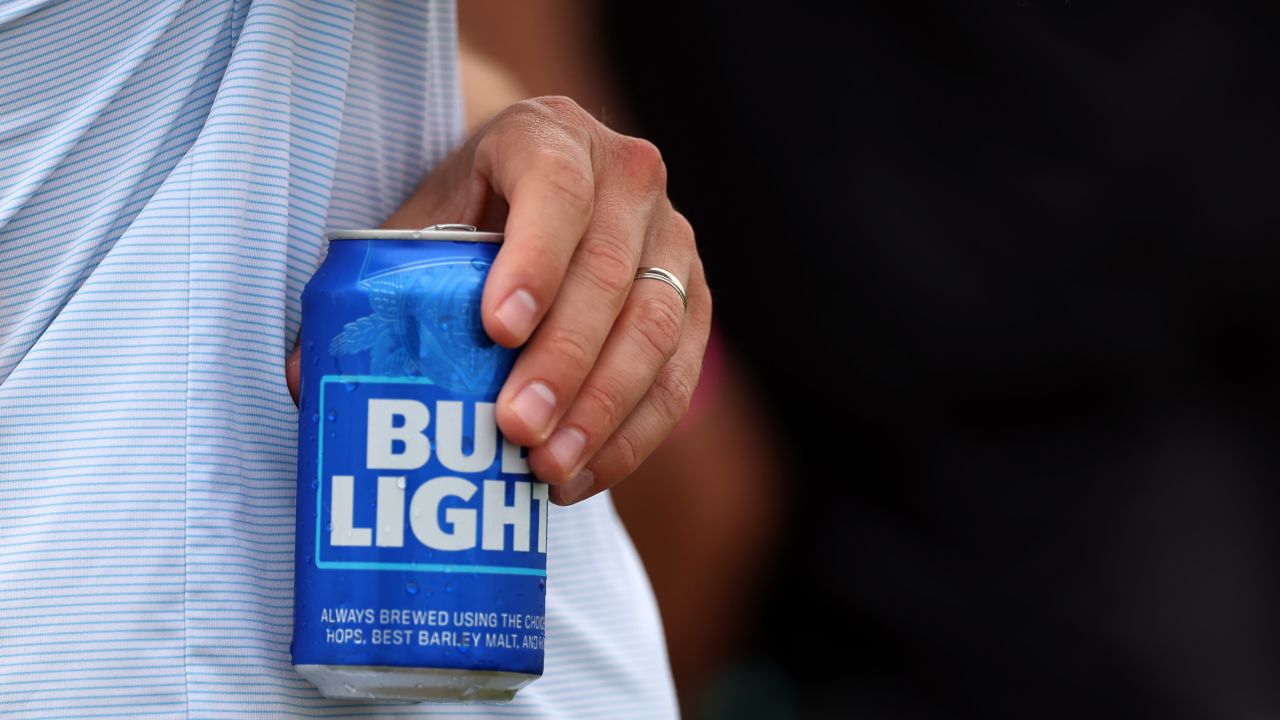 Someone holds a Bud Light beer during day three of the LIV Golf Invitational - DC at Trump National Golf Club on May 28, 2023 in Sterling, Virginia.