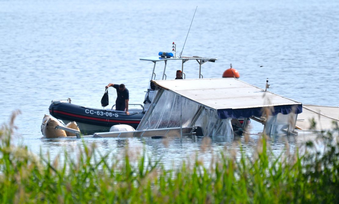 Italian authorities are seen inspecting the tourist boat that capsized and sank on Lake Maggiore.