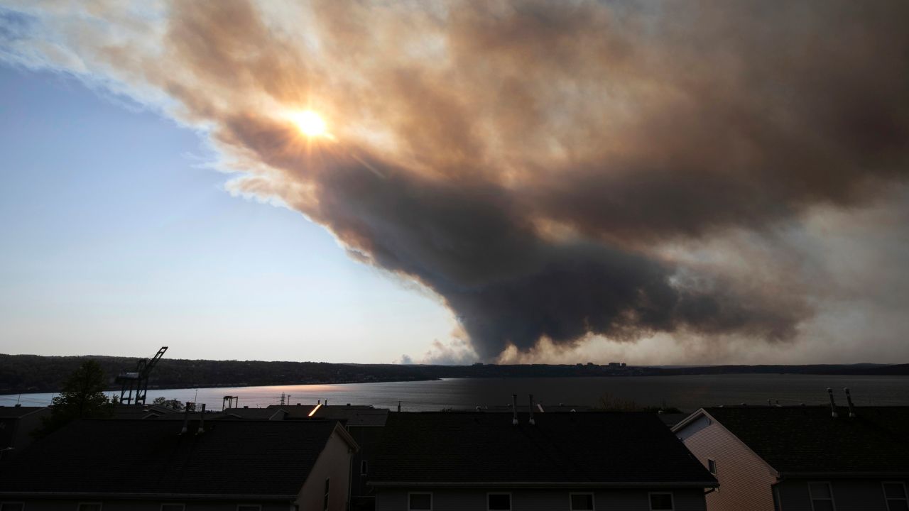 Thick plumes of heavy smoke fill the sky above Halifax, Nova Scotia, as an out-of-control fire in a suburban community quickly spread, engulfing multiple homes and forcing the evacuation of local residents.