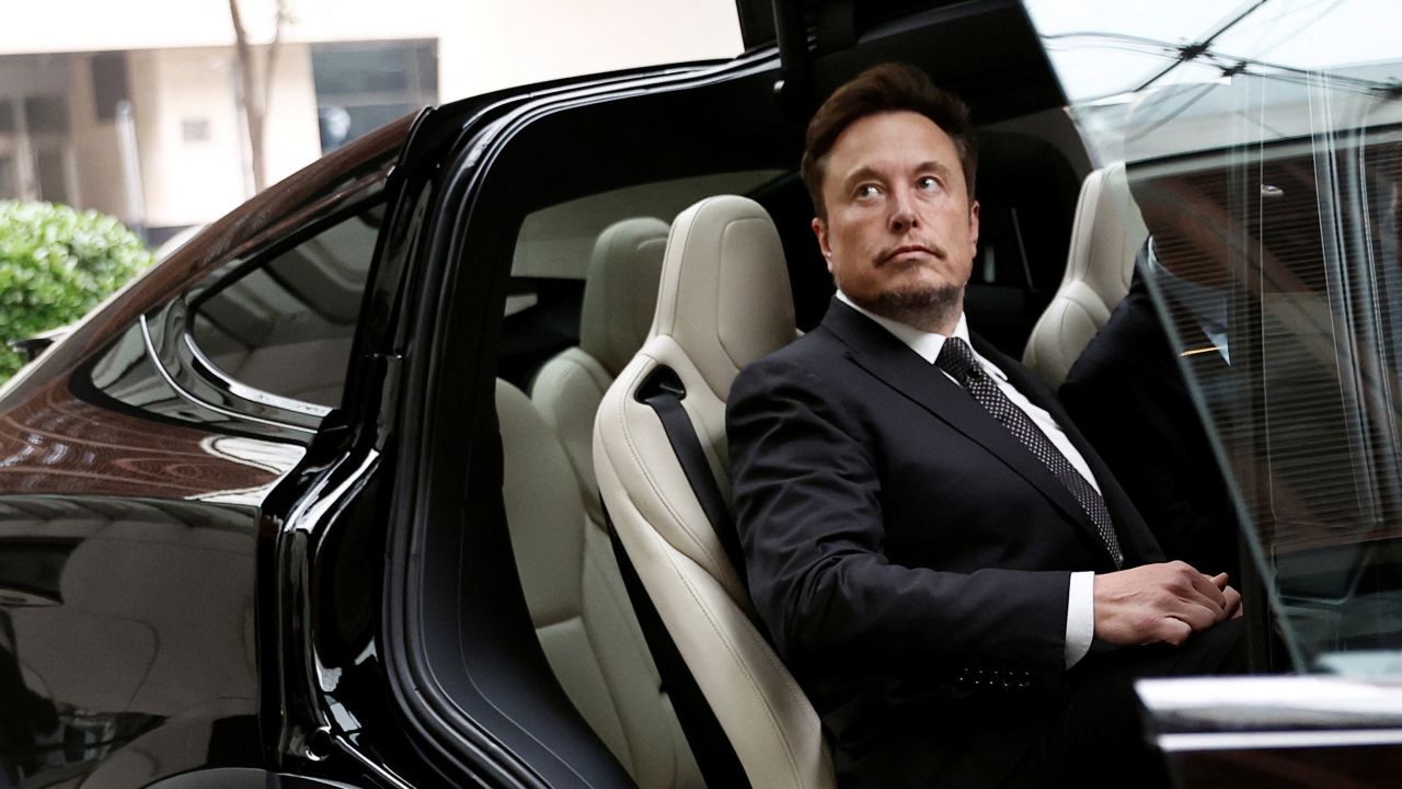 Tesla Chief Executive Officer Elon Musk gets in a Tesla car as he leaves a hotel in Beijing, China May 31, 2023. REUTERS/Tingshu Wang