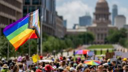 AUSTIN, TEXAS - APRIL 15: A Pride flag is seen held up in a crowd during preparation for a Queer March to the Texas State Capitol on April 15, 2023 in Austin, Texas. People from across Texas rallied together in protest against a slew of anti-LGBTQIA+ and drag bills being proposed among legislators. (Photo by Brandon Bell/Getty Images)