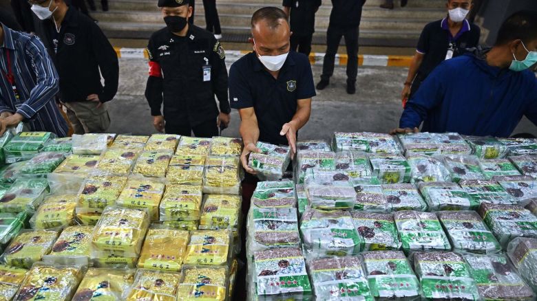 TOPSHOT - Thai policemen display packages of crystal methamphetamine before a press conference at the Narcotics Suppression Bureau in Bangkok on January 24, 2023. - More than a tonne of crystal meth was seized in less than a week, Thai police said Tuesday, after officers discovered some illicit stimulants hidden in tea and coffee bags. (Photo by Lillian SUWANRUMPHA / AFP) (Photo by LILLIAN SUWANRUMPHA/AFP via Getty Images)
