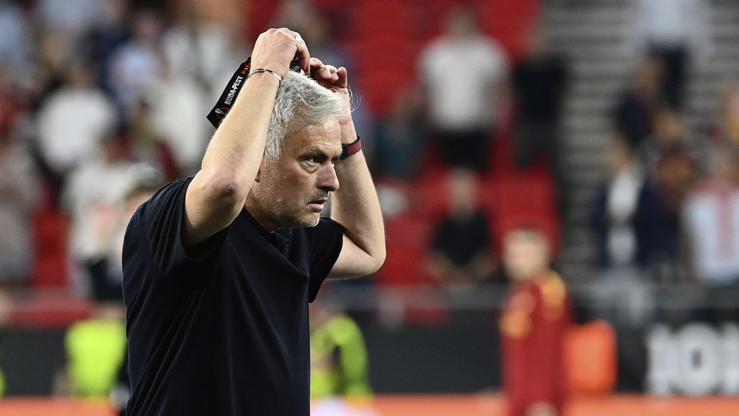José Mourinho takes off his runners up medal after Roma lost in the Europa League final against Sevilla.