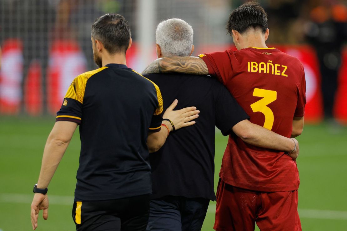 Mourinho (middle) embraces Roma defender Roger Ibañez (right) at the end of the Europa League final.