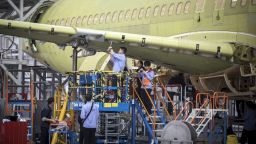 Technicians work on a Commercial Aircraft Corp. of China Ltd. (Comac) C919 aircraft as it stands under assembly at the Comac Shanghai Research and Development Center in Shanghai, China, on Thursday, May 4, 2017. China's first modern passenger jet took off on its maiden test flight on May 5, giving wings to President Xi Jinping's ambition of turning China into an advanced economy. Photographer: Qilai Shen/Bloomberg