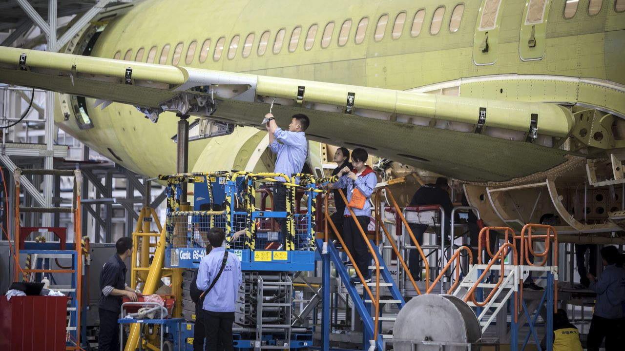 Technicians working on a COMAC C919 aircraft under assembly at the COMAC Shanghai Research and Development Center in 2017.