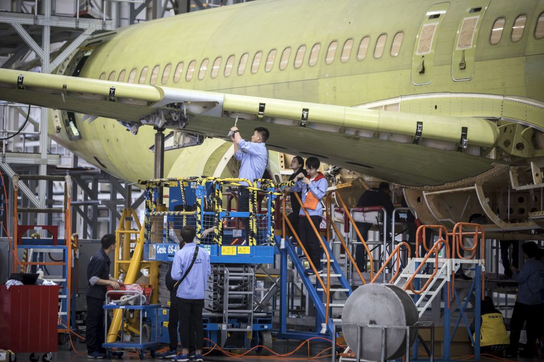 Technicians working on a COMAC C919 aircraft under assembly at the COMAC Shanghai Research and Development Center in 2017.