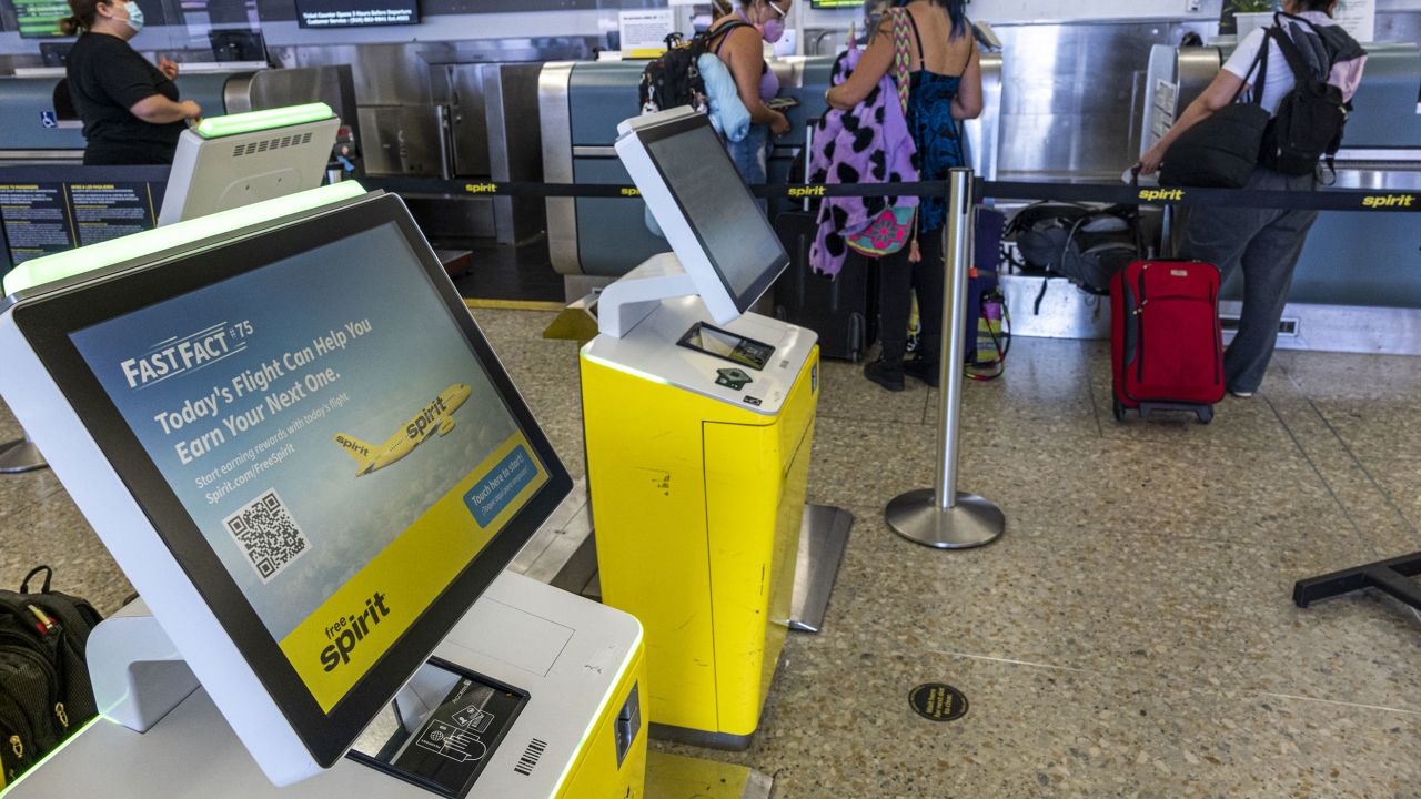 Spirit Airlines self check in kiosks at the Oakland International Airport in Oakland, California, U.S., on Tuesday, Jun. 21, 2022. JetBlue Airways Corp. raised its offer to purchase Spirit Airlines Inc., the latest move in a multi-billion dollar takeover contest with rival Frontier Group Holdings Inc., with both would-be suitors battling to secure a swift track to expansion as domestic travel demand surges. Photographer: David Paul Morris/Bloomberg via Getty Images