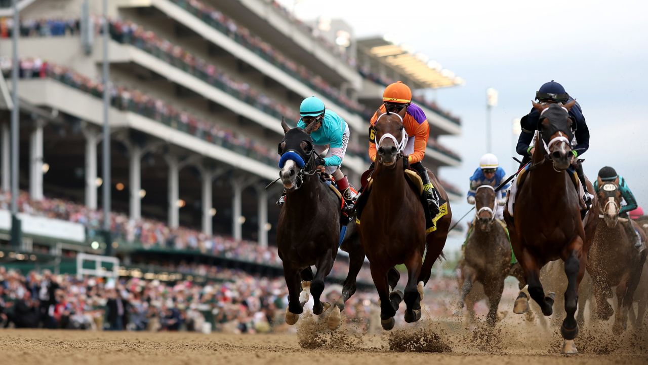 Jockey José Ortiz, center, sits atop of Kingsbarns as the field heads into the first turn during the 149th Kentucky Derby at Churchill Downs on May 6, 2023 in Louisville, Kentucky.