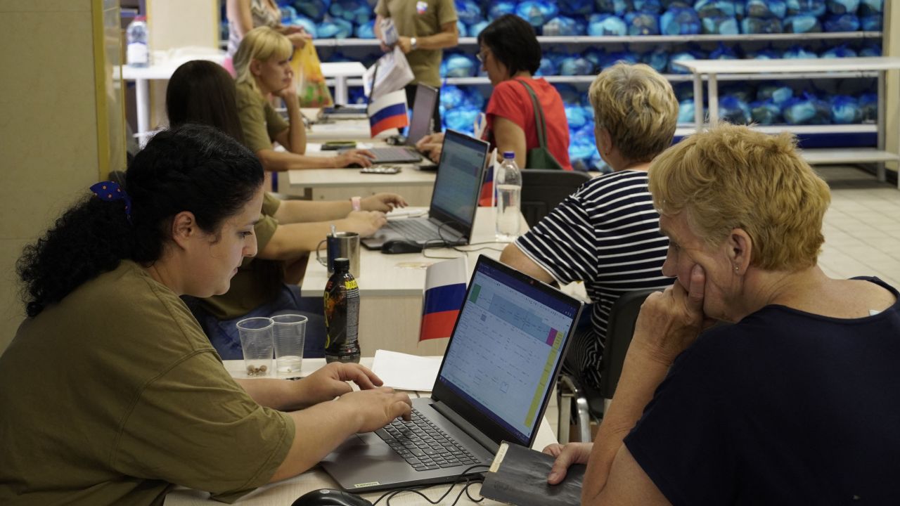 Workers at an aid centre administrated by Russia's ruling United Russia Party hand out food parcels in occupied Melitopol in this file photo.