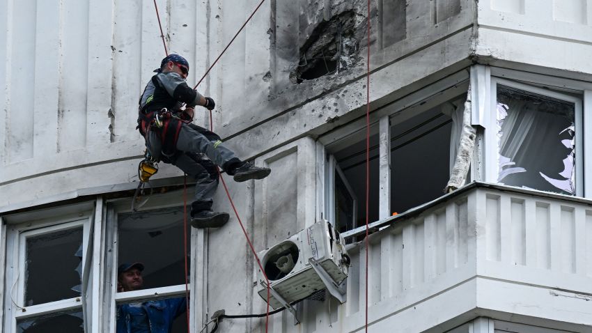 TOPSHOT - A specialist inspects the damaged facade of a multi-storey apartment building after a reported drone attack in Moscow on May 30, 2023. (Photo by Kirill KUDRYAVTSEV / AFP) (Photo by KIRILL KUDRYAVTSEV/AFP via Getty Images)