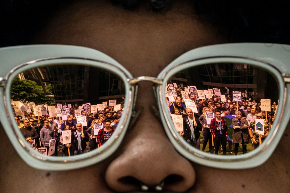 Amazon workers are reflected in the glasses of Shemona Moreno as she speaks during a <a href="https://www.cnn.com/2023/05/23/tech/amazon-walkout/index.html" target="_blank">walkout event</a> at the company's headquarters in Seattle on Wednesday, May 31. Workers participating in the event had two main demands: to have the e-commerce giant put climate impact at the forefront of its decision-making, and for it to provide greater flexibility for how and where employees work.