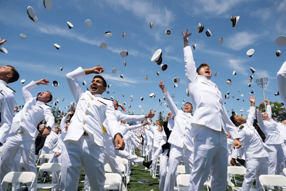 Graduates of the US Naval Academy throw their hats in the air at the end of the ceremony in Annapolis, Maryland, on Friday, May 26.