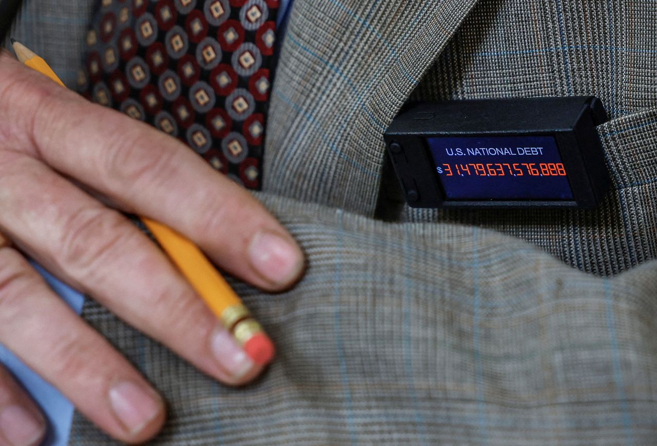 US Rep. Thomas Massie, a Republican from Kentucky, wears a pin that displays the US national debt on Tuesday, May 30. The homemade pin <a href="https://www.cnn.com/2023/05/31/politics/debt-deal-spending-decisions-analysis/index.html" target="_blank">updates the debt in real time</a>.