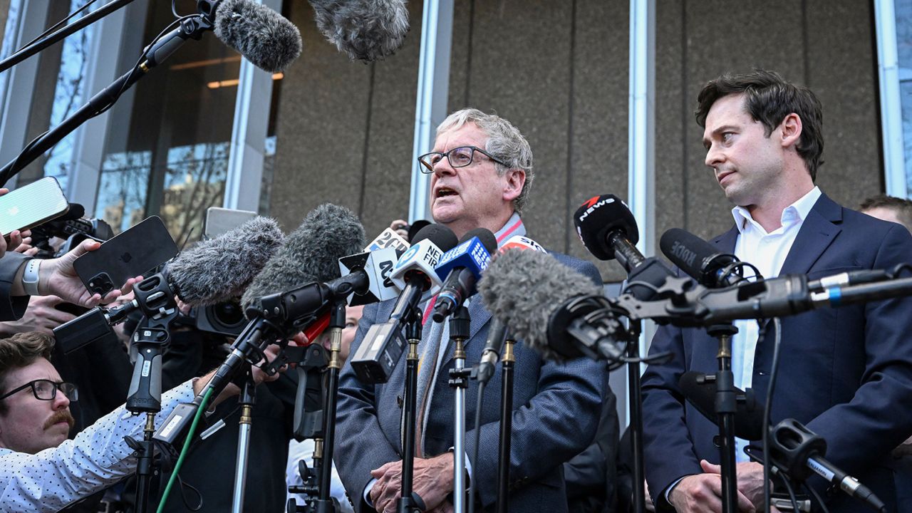 Journalists Chris Masters (L) and Nick McKenzie (R) talk to the media outside the Federal Court of Australia in Sydney on June 1, 2023. Ben Roberts-Smith, one of Australia's most decorated soldiers, lost a landmark defamation case against major newspapers on June 1 after a bruising trial that saw accusations of murder, domestic violence, witness intimidation and war crimes.