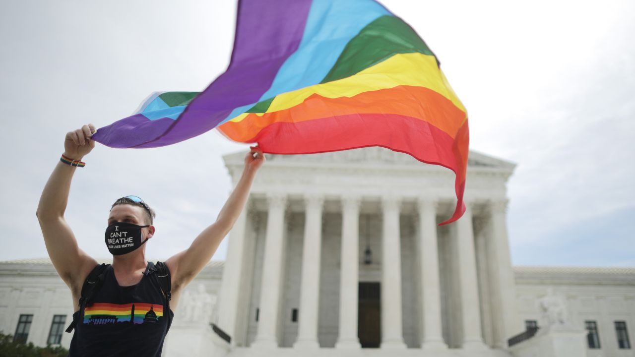 Joseph Fons holding a Pride Flag in front of the Supreme Court on June 15, 2020. 