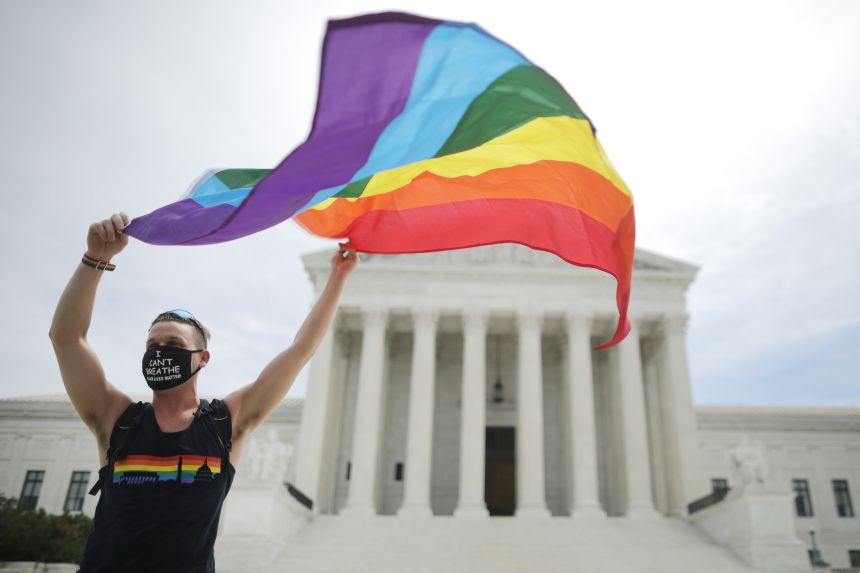 Joseph Fons holding a Pride Flag in front of the Supreme Court on June 15, 2020. 