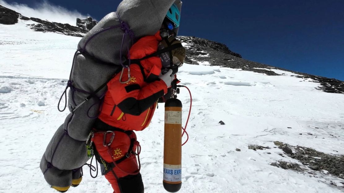Ngima Tashi Sherpa carries a Malaysian climber from the death zone at Mount Everest on May 18, 2023.