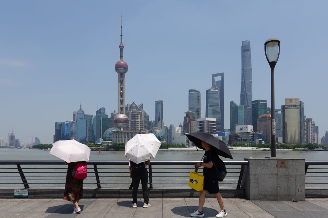 Tourists holding umbrellas visit Shanghai during a heat wave on May 29, 2023. The city recently recorded its highest May temperature in more than 100 years.