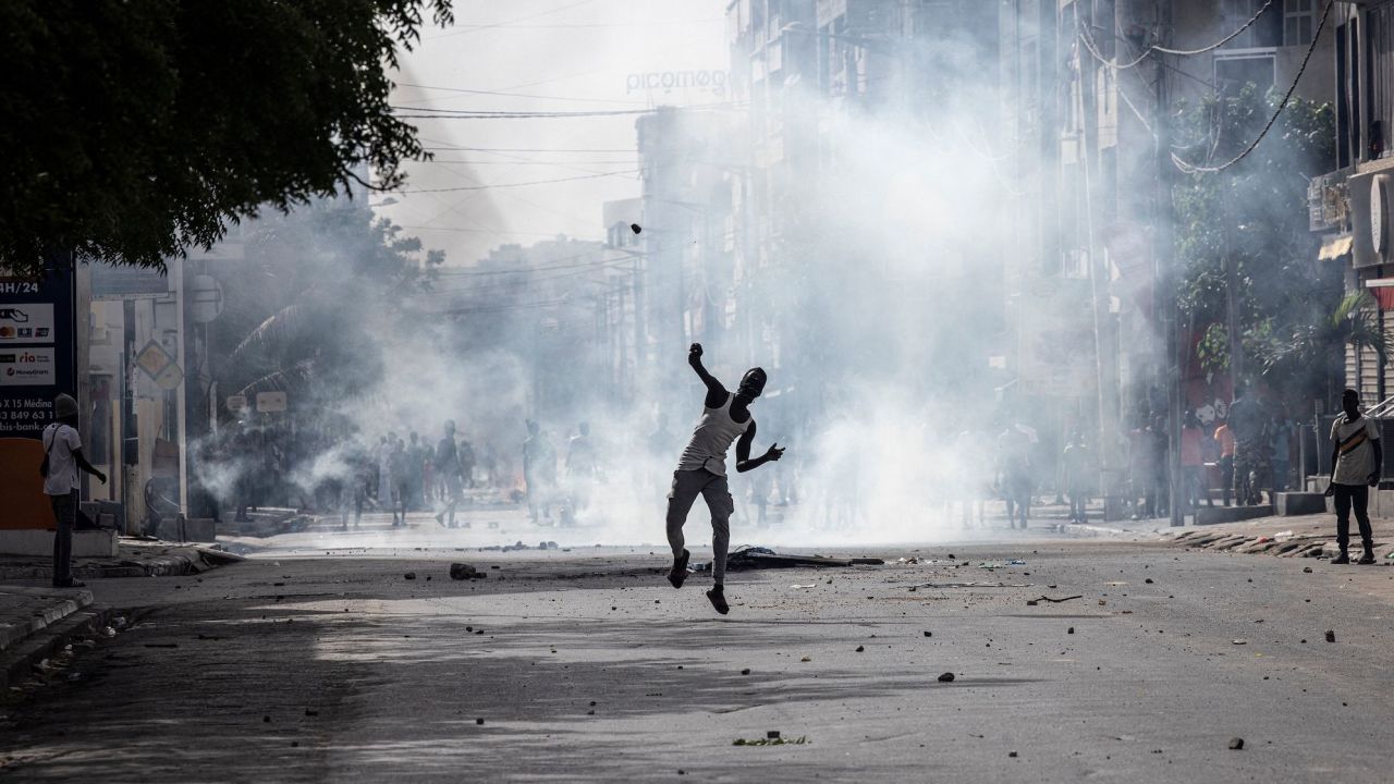 A demonstrator hurls a stone at police in Dakar on June 1, 2023 during a protest.