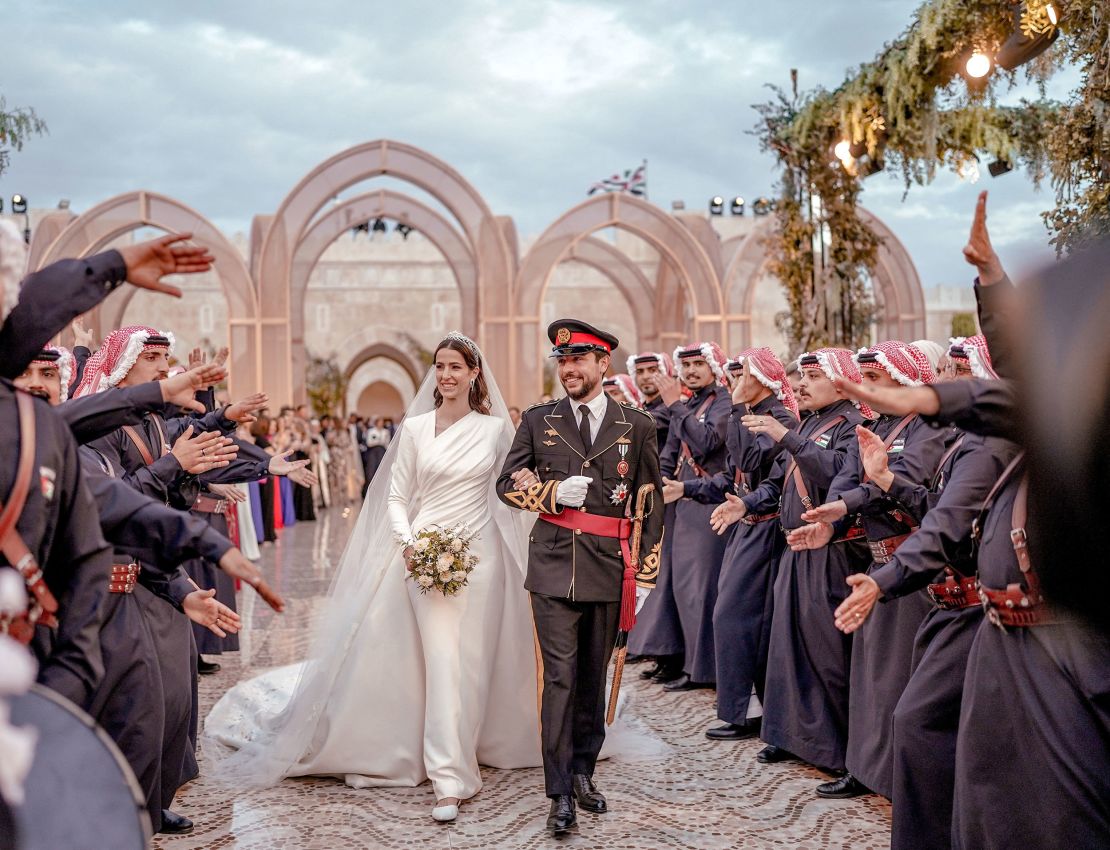 Jordan's Crown Prince Hussein and Rajwa Alseif walk together on the day of their royal wedding, in Amman, Jordan.