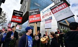 Writers on strike march with signs on the picket line on day four of the strike by the Writers Guild of America in front of Netflix in Hollywood, California on May 5, 2023. More than 11,000 Hollywood television and movie writers are on their first strike since 2007 after talks with studios and streamers over pay and working conditions failed to clinch a deal. 