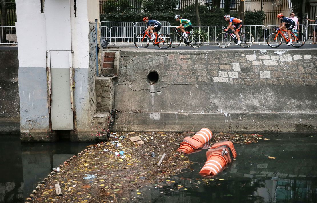 RIO DE JANEIRO, BRAZIL - AUGUST 07:  Competitors ride past an 'eco barrier' along a polluted canal in the Leblon neighborhood during the Women's Road Race on Day 2 of the Rio 2016 Olympic Games  on August 7, 2016 in Rio de Janeiro, Brazil. The Rio 2016 Olympic Games run until August 21.