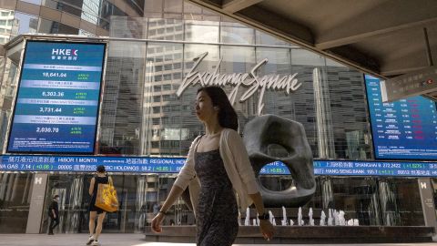 A pedestrian passes by the Hong Kong Stock Exchange electronic screen in Hong Kong, Friday, June 2, 2023. Asian stock markets followed Wall Street higher on Friday ahead of an update on the U.S. jobs market after Federal Reserve officials indicated they might skip another interest rate hike this month. (AP Photo/Louise Delmotte)