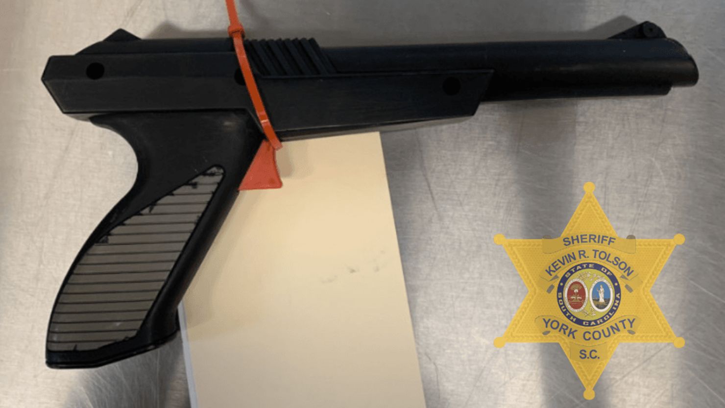 A spray-painted Nintendo "Duck Hunt" game pistol.