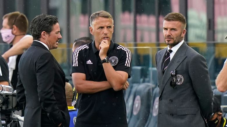 David Beckham, owner and president of soccer operations for Inter Miami, right, talks with head coach Phil Neville, center, and David Gardner, left, before an MLS soccer match between Inter Miami and CF Montréal, Wednesday, May 12, 2021, in Fort Lauderdale, Fla.