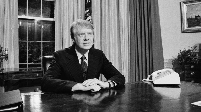 Pres. Jimmy Carter is seated at his desk in the Oval Office prior to delivering his message on energy, Monday, April 19, 1977, Washington, D.C. The President made his statements on nationwide television and radio saying that many of his proposals on energy will be unpopular. (AP Photo/Charles W. Harrity)